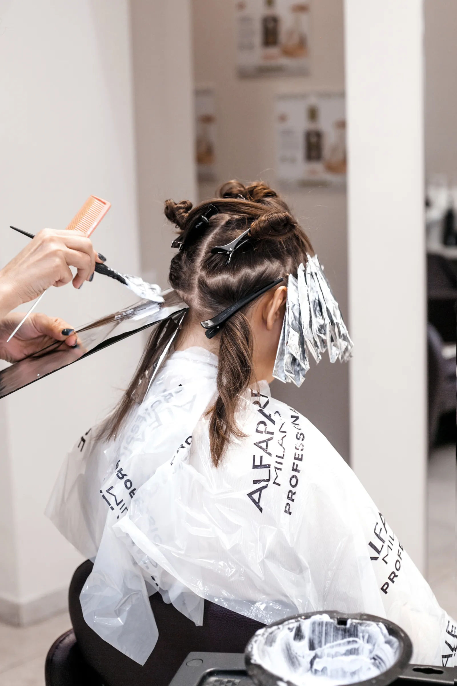 Professional hair treatment with color application in a beauty salon