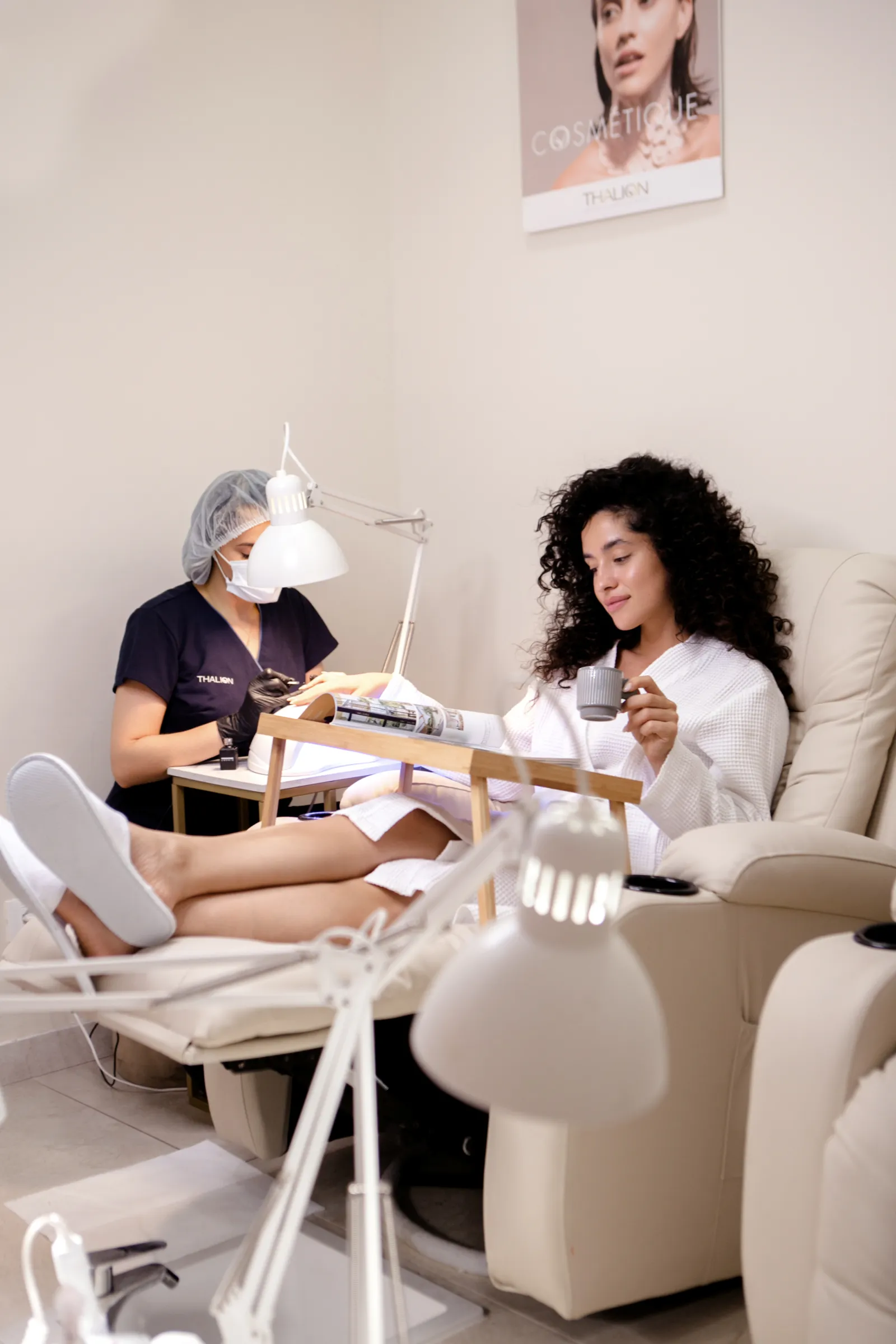 Professional pedicure treatment in a beauty salon with a client relaxing in a comfort chair
